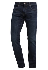 Jeans de denim azul oscuro con corte ajustado, que presentan un diseño tradicional de cinco bolsillos y costuras en contraste a lo largo de las costuras.