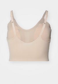 Lys beige crop-top-lignende BH med brede stropper, en glatt tekstur og et samlet mønster bak i midten. Ingen polstring eller spile.