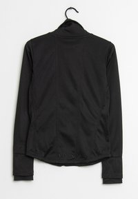 Schwarze Jacke mit hohem Kragen, langen Ärmeln und figurbetontem Schnitt. Verfügt über dezente Nähte und ein kleines "Bench"-Logo am Saum.