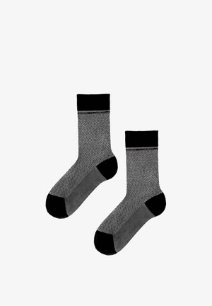 Pair of gray patterned crew socks with black cuffs, heels, and toes, displayed side by side on a white background.