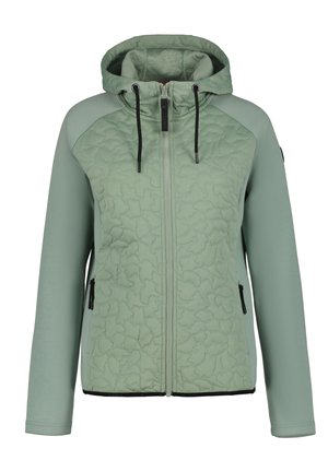 Veste à capuche vert clair avec devant matelassé, manches lisses, fermeture éclair noire et poches latérales zippées.
