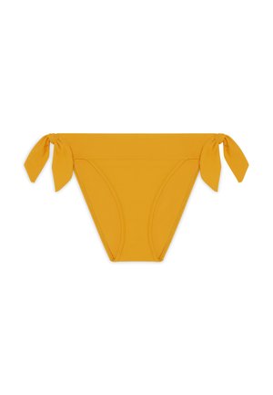 Žuti donji deo bikinija sa vezicama sa strane, izrađen od glatkog materijala. Ima srednji kroj i bešavnu dizajnersku obradu.
