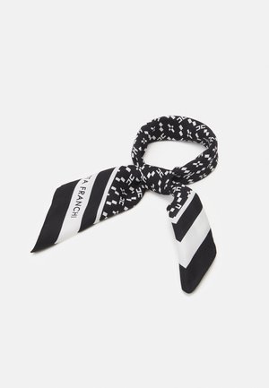Black and white patterned neck scarf with geometric designs and contrasting diagonal stripes, loosely knotted on a white background.