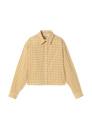 Chemise à manches longues boutonnée à carreaux jaunes et blancs avec col, ourlet raccourci et coupe classique, posée à plat sur fond blanc.