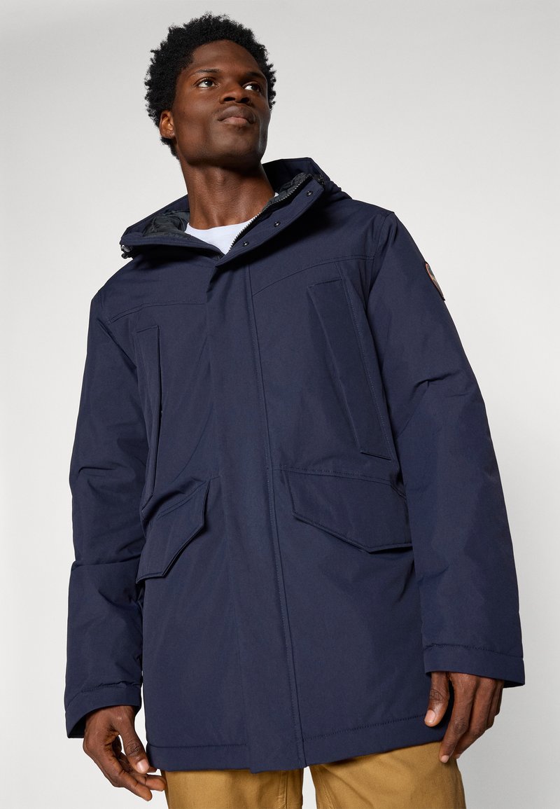 Parka bleu marine avec capuche, dotée de deux poches avant, d'une fermeture éclair et d'une finition texturée. Le tissu semble durable et résistant aux intempéries.