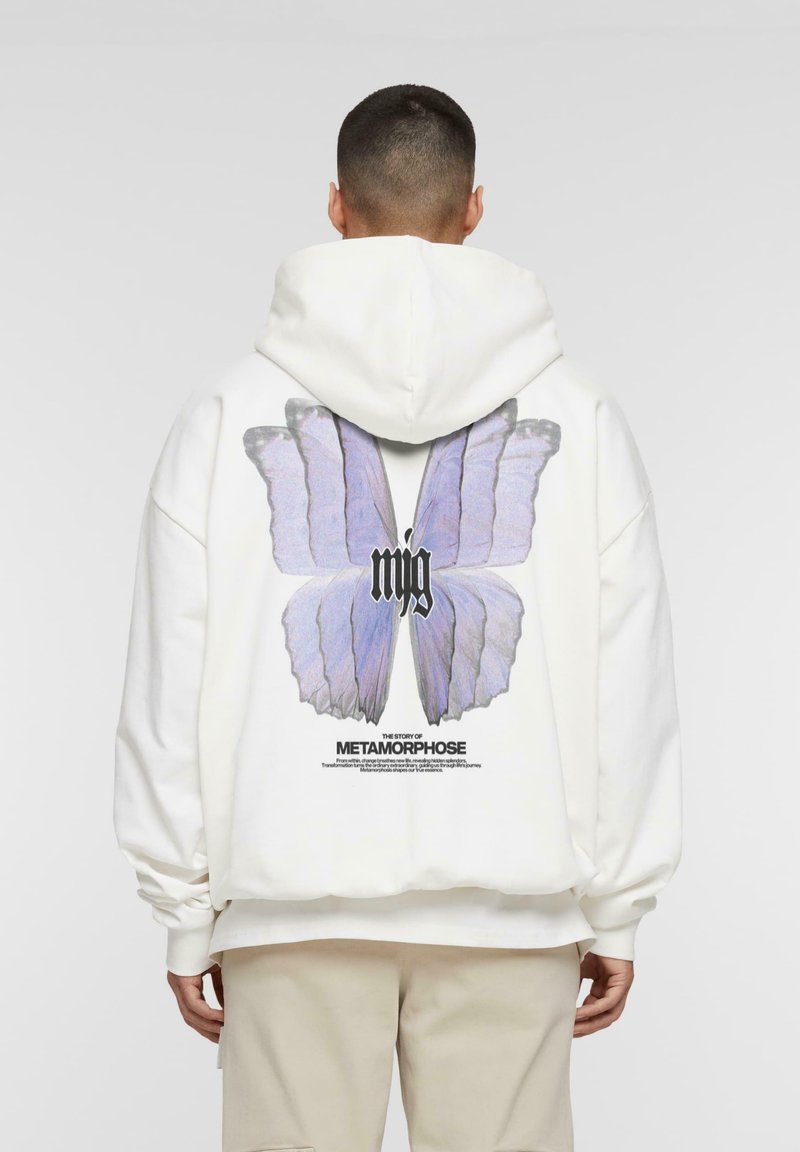 White hoodie featuring a large purple butterfly graphic on the back, with the text "METAMORPHOSE" below. Soft fabric, relaxed fit.