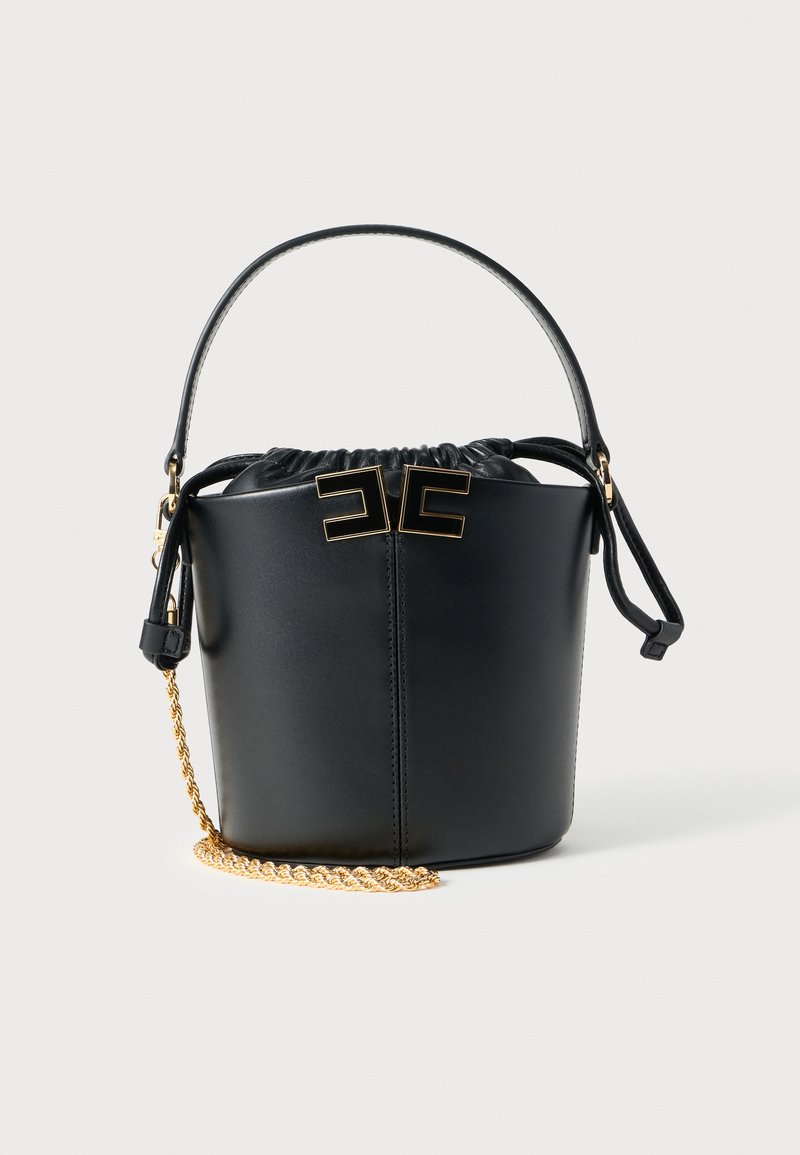 Black leather bucket bag with a drawstring top, gold hardware accents, and a removable chain strap. Features a smooth texture and circular shape.