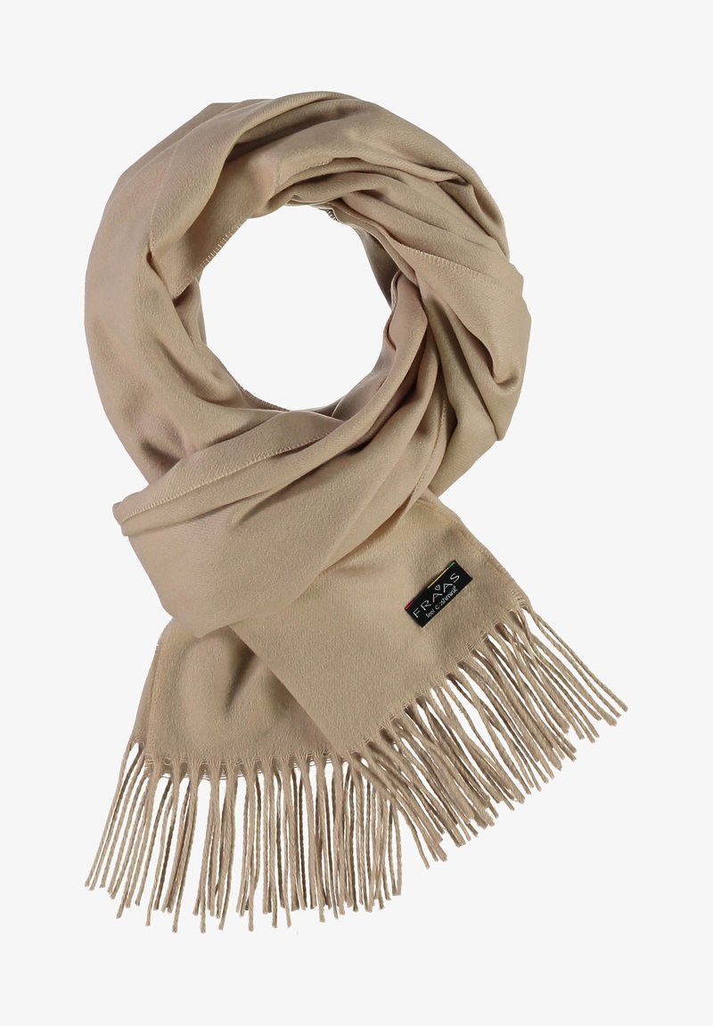 Beige tørklæde lavet af blødt stof, med et snoet design og frynset kanter samt en lille sort mærkat med flerfarvet tekst.