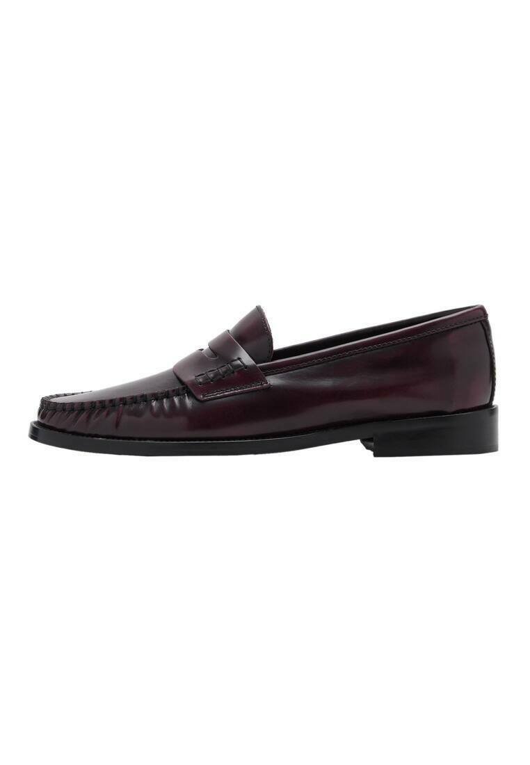 Men’s dark brown leather penny loafer with black sole and stitching detail along the toe, shown in side profile.