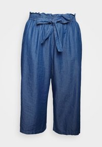 Culottes en denim avec une taille élastique, un détail noué et une coupe ample. Elles présentent une couleur bleu foncé unie et une texture douce et légère.