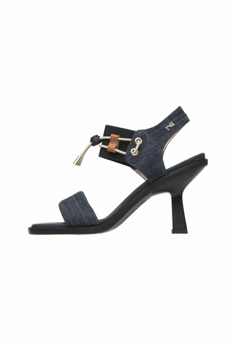 Denim-stil hæl-sandaler med to stropper; mørkeblåt tekstilmateriale, sort bund, guldhardware-detaljer og elastisk sideelement.