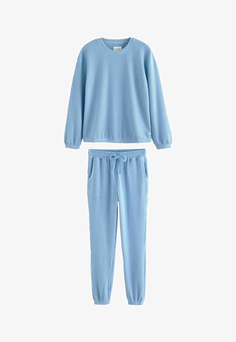 Light blue ribbed loungewear set, featuring a long-sleeve top with a round neck and elastic cuffs, paired with matching drawstring pants with pockets.