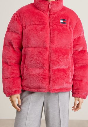 Faux fur pink puffer jacket featuring a high collar, zipper closure, and logo patch. The design includes horizontal quilted panels and pockets.