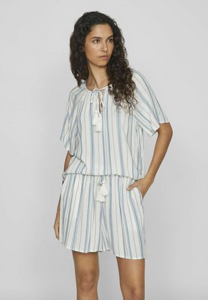 Mono ligero a rayas en blanco y azul, con un escote redondo, cordón ajustable y adornos de borlas. Mangas sueltas y bolsillos laterales.