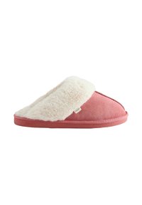 Pink suede slipper with a white faux fur lining, open back design, contrasting stitching, and a subtle brand tag on the side.