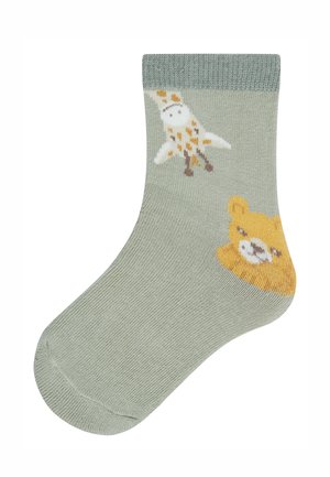 Light green sock with knitted giraffe and bear faces near the ankle, featuring yellow and white details.