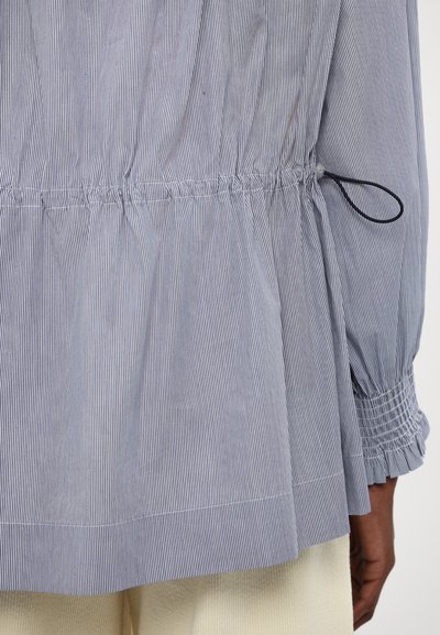 Striped cotton shirt featuring a cinched waist, puffed sleeves, and elasticated cuffs. Color scheme includes blue and white stripes.