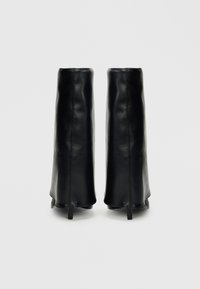 Μαύρα δερμάτινα μποτάκια μέχρι τον αστράγαλο με λεία υφή, κωνικό σχήμα και ελάχιστες ραφές. Διαθέτουν χαμηλά, τετράγωνα τακούνια.