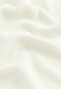 Waffle-textured, soft white fabric with a subtle grid pattern. It drapes softly with visible texture and a light, airy appearance.