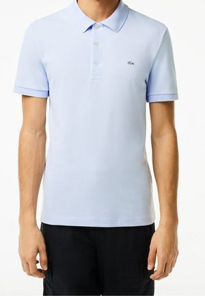 Light blue polo shirt made of smooth fabric, featuring a three-button placket and a small embroidered logo on the left chest. Short sleeves.