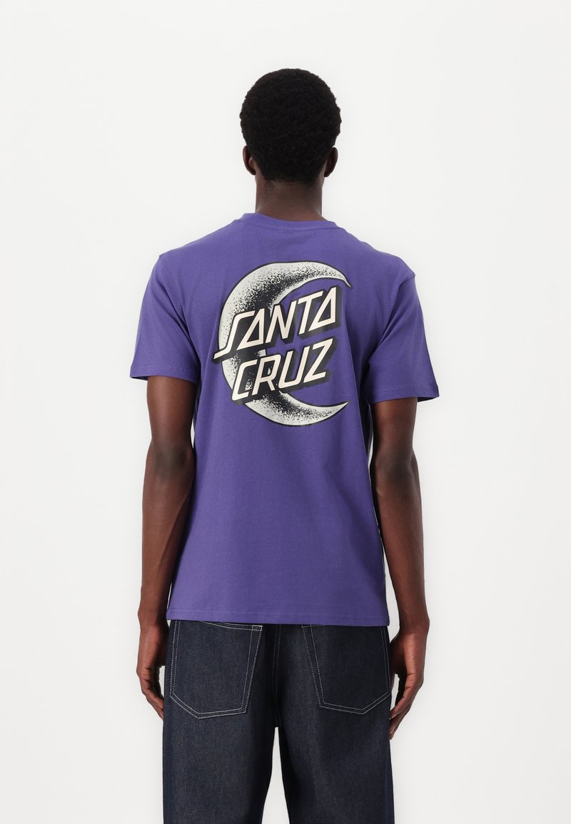 Purple cotton t-shirt featuring a large white and black graphic of a crescent moon with the text "SANTA CRUZ" on the back.