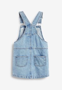 Denim overall dress in light blue. Features adjustable straps, a back yoke seam, and two large front pockets. Smooth texture, casual design.