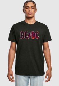 Svart bomull T-skjorte med svart og hvit "AC/DC" logo med lyn-design. Korte ermer og rund hals.