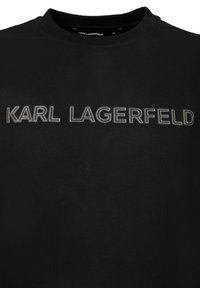 Sudadera negra de algodón con cuello redondo que presenta "KARL LAGERFELD" bordado en plata sobre el pecho. Textura suave y diseño minimalista.