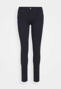 Jeans ajustados en denim azul marino oscuro, con una textura suave, diseño de cinco bolsillos, cinturilla estándar y cierre delantero con botón.