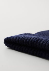 Navy knitted wool scarf, folded, with a ribbed texture. Features a soft, thick fabric with slight fuzziness and clean edges.