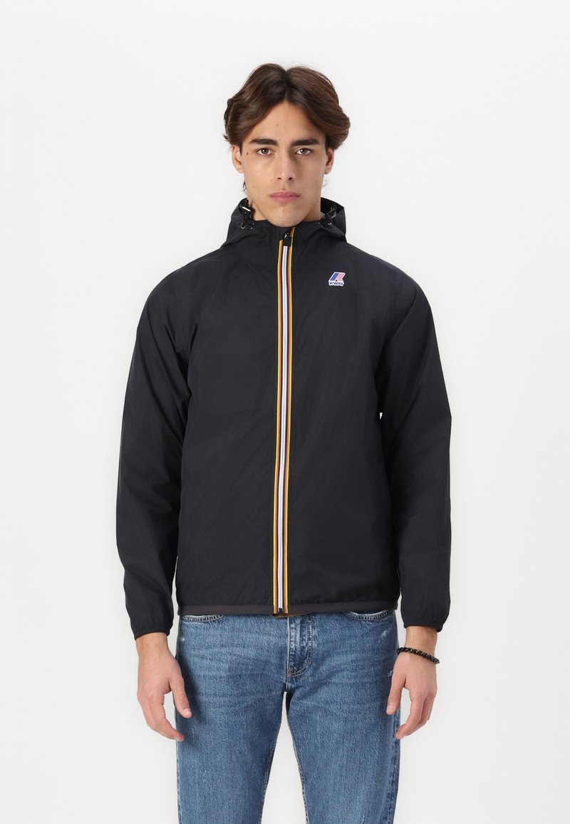 Black windbreaker jacket with a yellow and blue front zipper, elastic cuffs, and a hood, made of lightweight material.