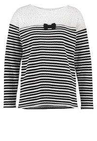 Musta-valkoinen raitapaita, jossa on pitkät hihat, pitsikaitale ja pieni nauhadetaili keskellä. Rakennekangas.