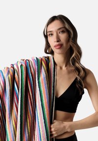 Striped blanket made of soft, textured fabric in vibrant colors, featuring bold lines in red, green, blue, yellow, and pink hues.