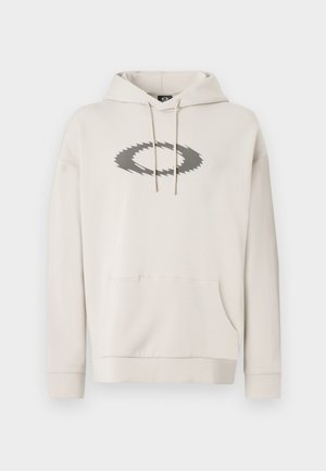 Beige Kapuzenpullover aus weichem Stoff, mit großem grauen Logo-Design auf der Vorderseite, Kängurutasche und gerippten Bündchen.