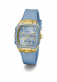 Orologio Guess con un cinturino in silicone azzurro esagonale, dettagli in tono oro, finitura testurizzata e un quadrante azzurro con tre sottodial.