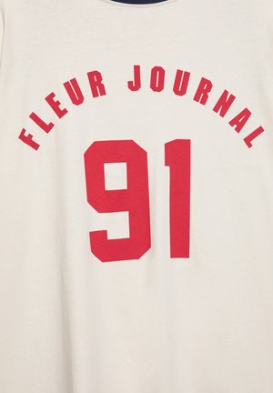 Red text "FLEUR JOURNAL" curved above the large number "91" printed on a light cream fabric background.