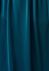 Teal fabric drape with a smooth texture, featuring soft, flowing lines and a subtle sheen, showcasing its lightweight and flexible design.