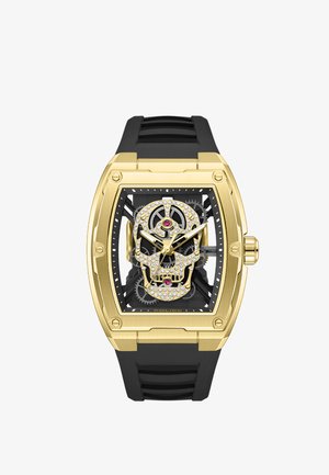 Gouden rechthoekig polshorloge met zwarte band, skeletwijzerplaat met een met kristallen bezette schedel en zichtbare tandwielmechanismen.