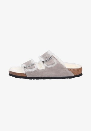 Gray suede slide sandal with white faux fur lining, two adjustable straps, and a cork footbed. Black rubber outsole for traction.