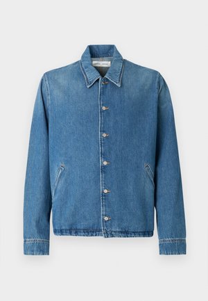 Denim jacket in light blue, featuring a pointed collar, button closures, side pockets, and long sleeves with clean hemmed edges.