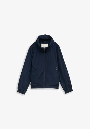 Marineblaue Reißverschlussjacke mit hohem Kragen, elastischen Bündchen und zwei vorneliegenden Reißverschlusstaschen, flach auf weißem Hintergrund ausgelegt.