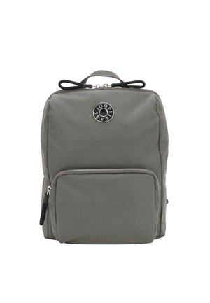 Gray nylon backpack with a smooth texture, featuring a front zip pocket, a round logo patch, and adjustable shoulder straps.