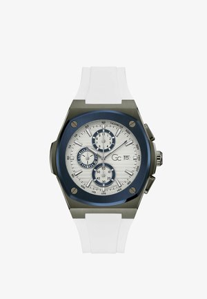 Chronografur med en sølvtekstureret skive, blå accenter og en hvid silikone-rem. Har tre undertavler og tachymeter markeringer.