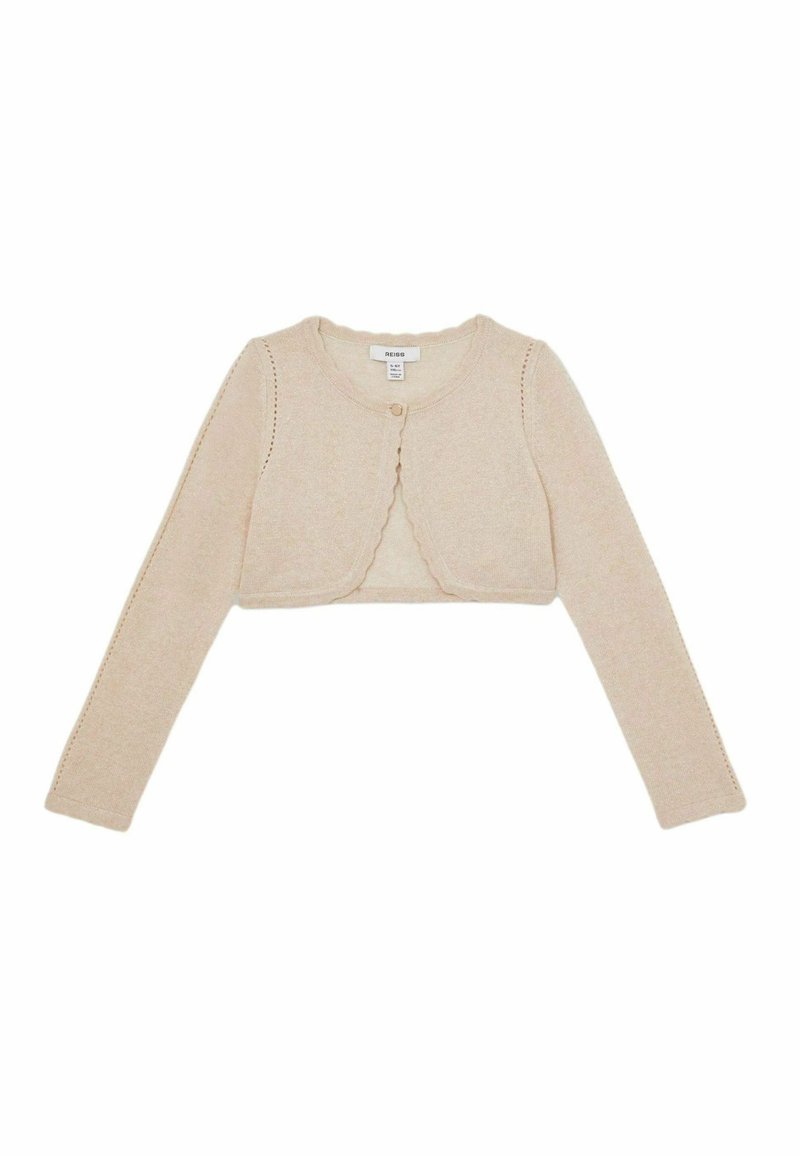 Lühike beež kardigan, mis on valmistatud kudumkangast, omab pikki varrukaid, lainelisi servasid ning ühte nööpsu ees.