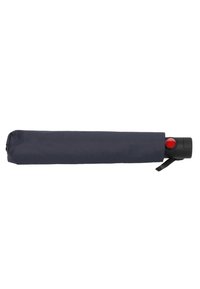 Navy folded umbrella with a black handle featuring a red button, secured with a strap. Textured fabric cover. Compact cylindrical shape.