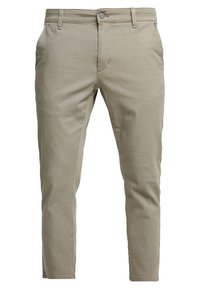 Chino in cotone beige con vestibilità slim, caratterizzati da chiusura con bottone frontale, cinque tasche e una trama sottile.