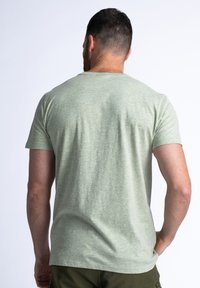 Light green short-sleeve t-shirt in a soft, textured fabric. Classic crew neck design with a relaxed fit. Rear view shown.