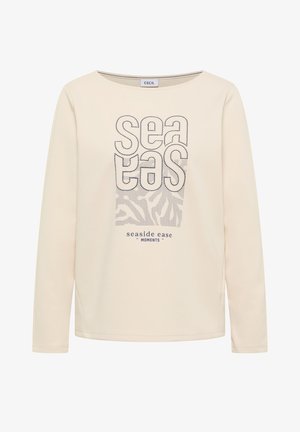 Cremefarbenes Langarmshirt mit aufgesticktem Schriftzug "sea eas" und Wellenmuster, darunter der Aufdruck "seaside ease moments".