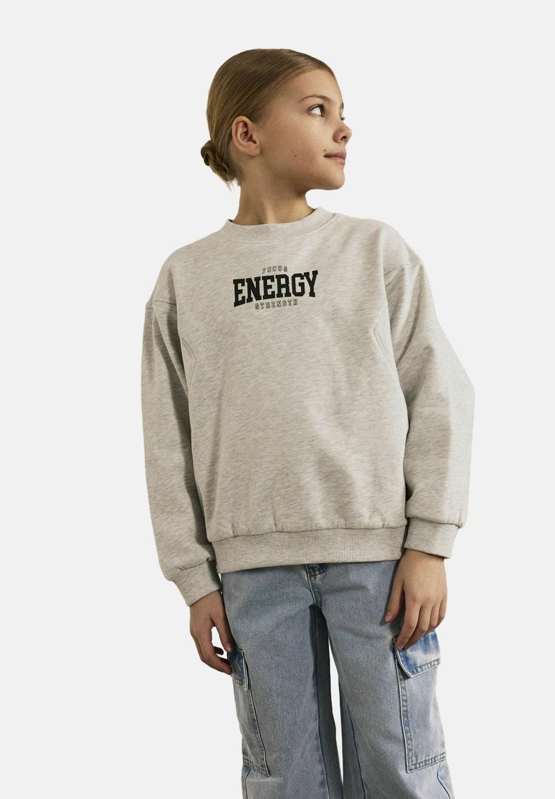 Light grey sweatshirt with ribbed cuffs and hem, featuring a black print that reads "FOCUS ENERGY". Worn with light blue cargo pants.
