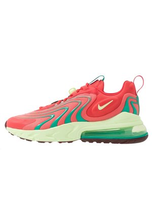 Jasnoróżowy sneaker z turkusowymi falistymi wzorami, kremową podeszwą, widoczną poduszką powietrzną i małym białym logo Swoosh po boku.